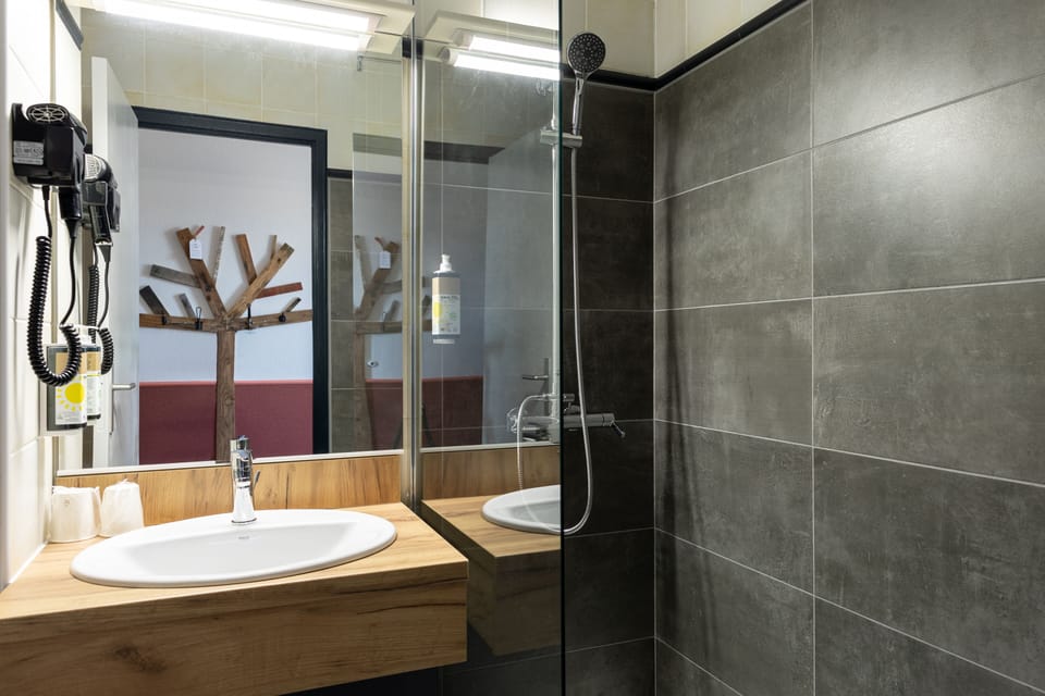 Bathtub, eco-friendly toiletries, hair dryer, towels