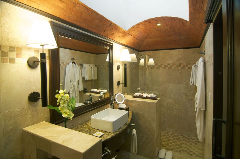 Shower, designer toiletries, hair dryer, bathrobes