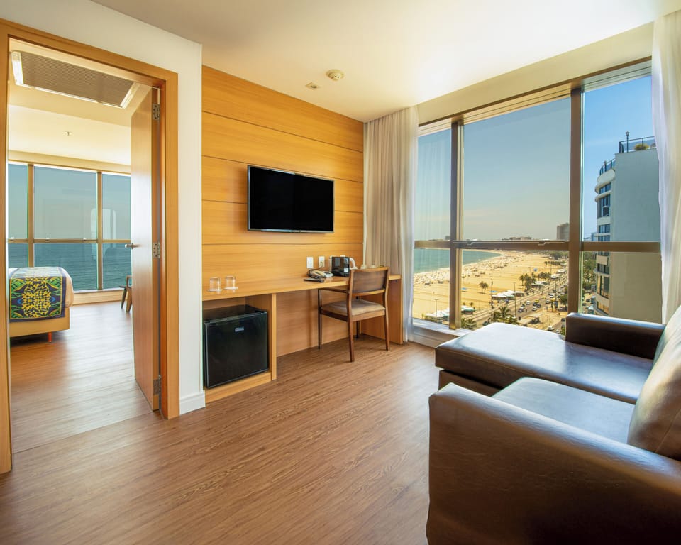 Suite, Sea View | Minibar, in-room safe, desk, laptop workspace