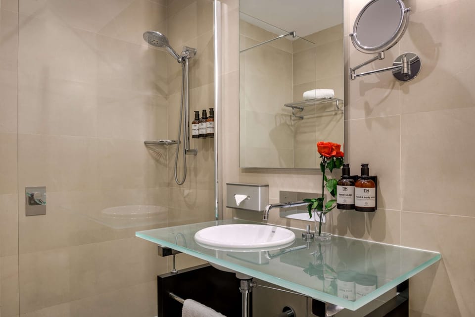 Bathtub, rainfall showerhead, eco-friendly toiletries, hair dryer