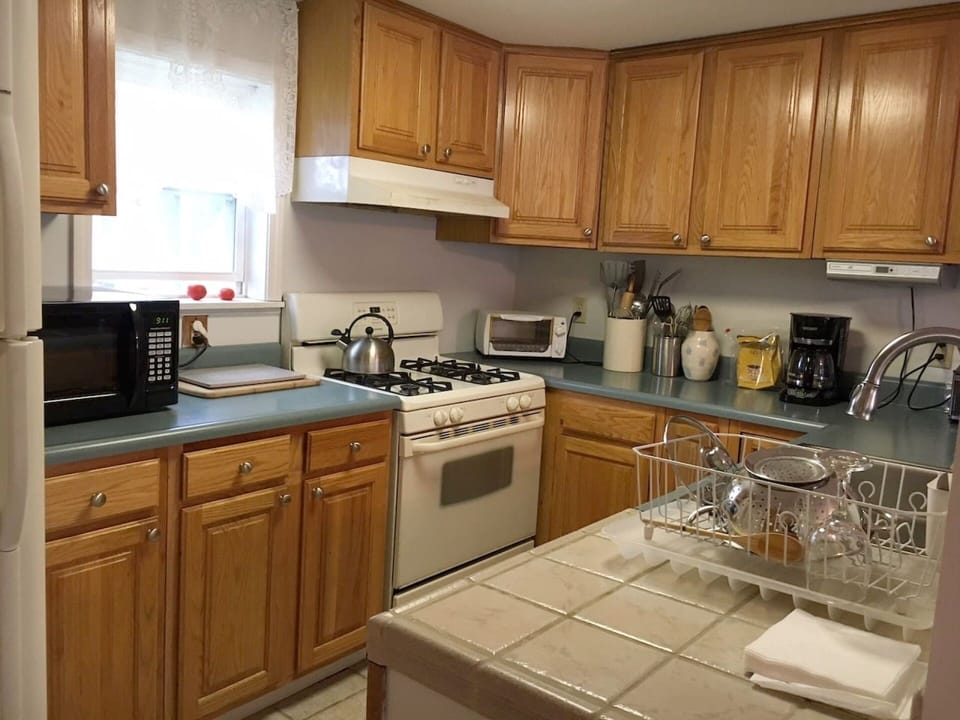 Fully equipped kitchen with stove, dishwasher, microwave, refrigerator and more