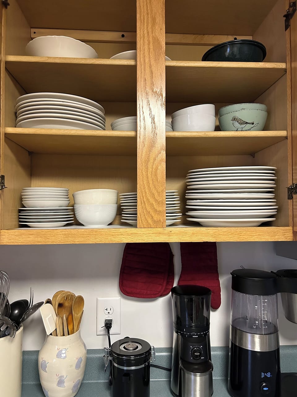 Cabinets stocked with plates, bowls, etc. for a large group