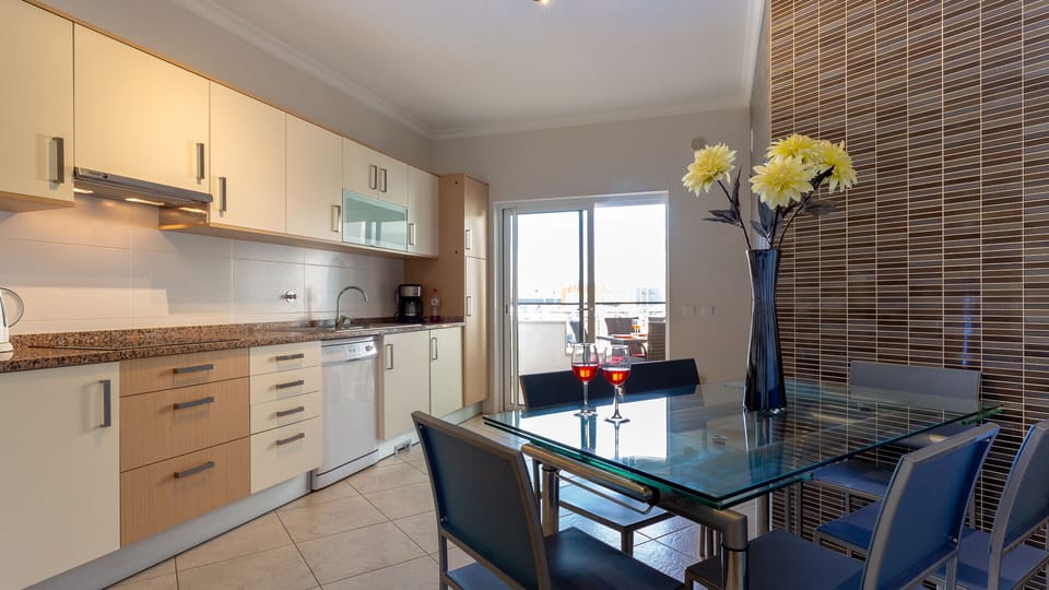 Kitchen has a table seating six, washing machine and the essential dishwasher  