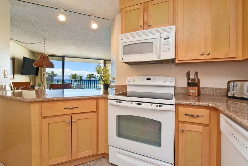 Enjoy cooking at your fully furnished kitchen with white appliances