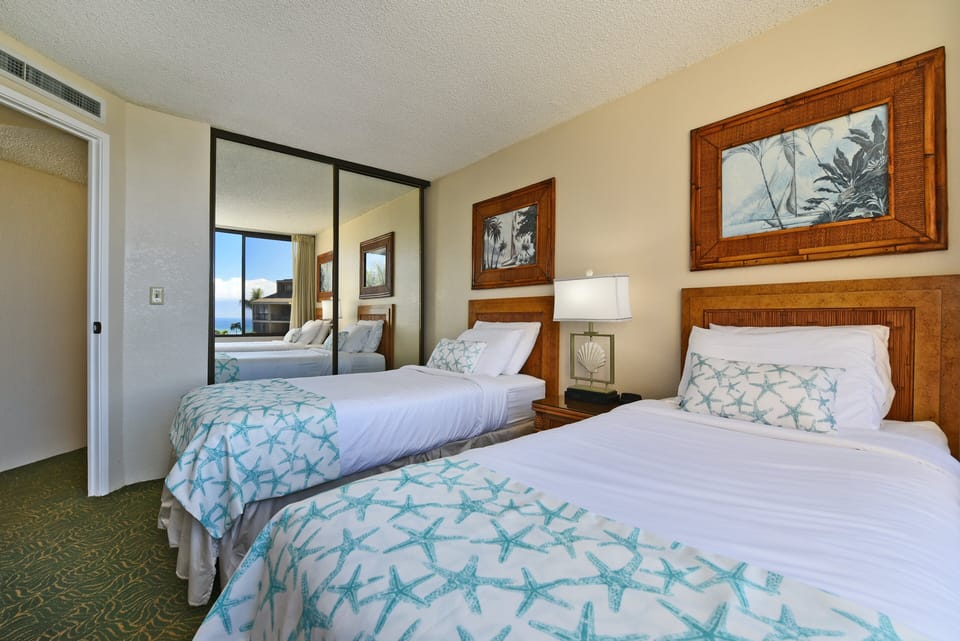 Guest bedroom features 2 twin size beds that can be converted into king