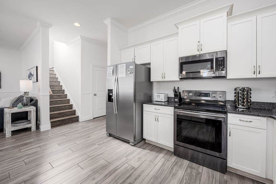 Spacious kitchen. Stairs lead to 2nd floor.