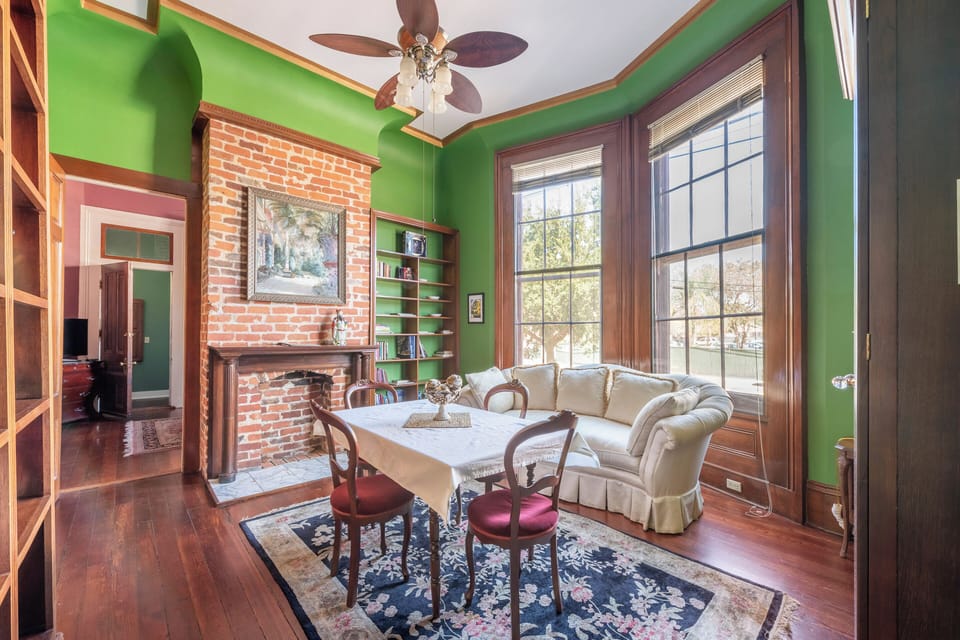 Living/dining room with antique table & sofa