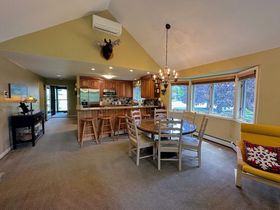 Dining area with round table and barstool seating
