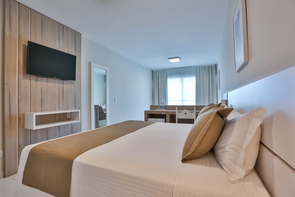 Deluxe Suite, Sea View | Minibar, in-room safe, laptop workspace, blackout drapes