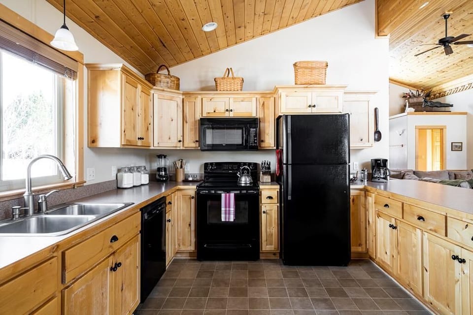 Full kitchen with plenty of cookware and utensils.