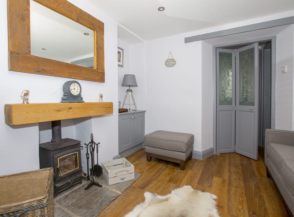 Cosy lounge with a log burner and free logs.