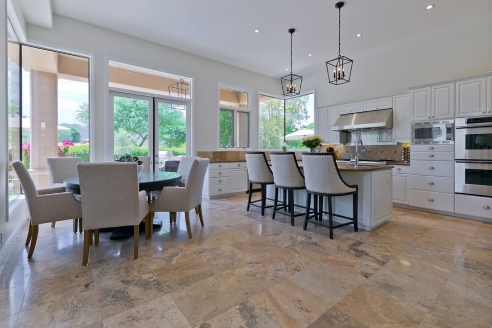 Large open kitchen with bar seating for 3 and kitchen table that seats 6.