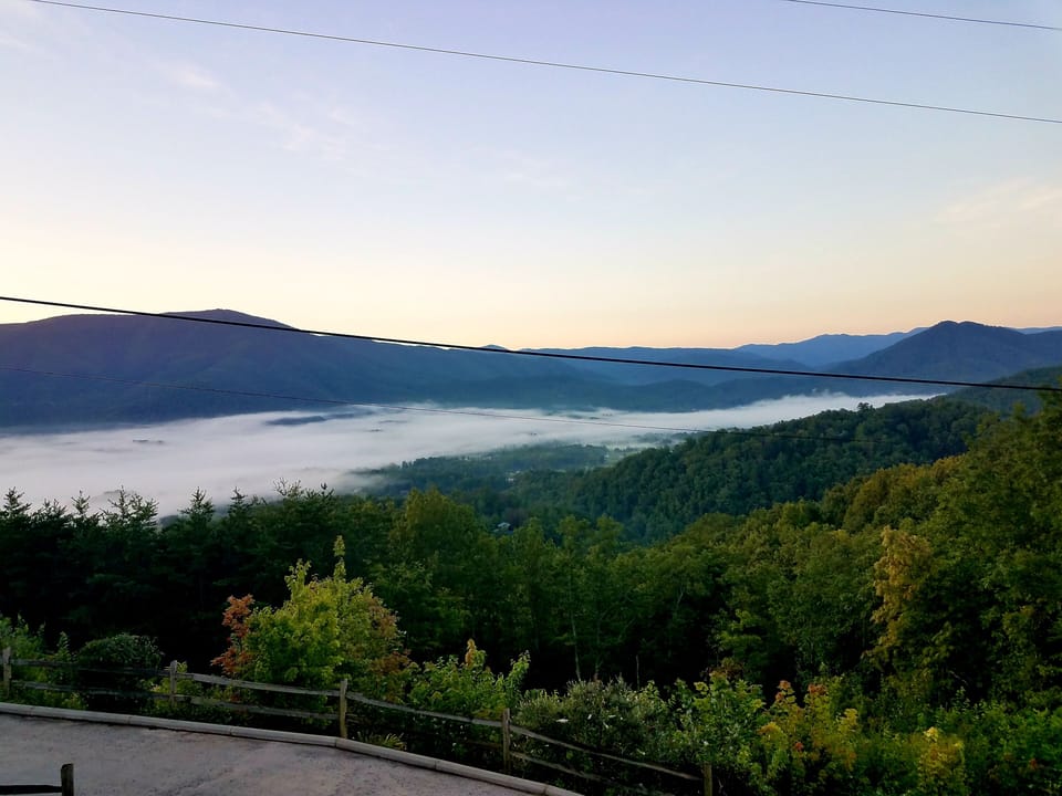 This is the stunning summer morning view when fog seeps over the valley.