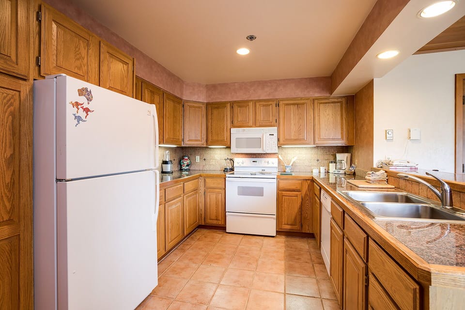 Your fully equipped kitchen features rich wood cabinets, granite counters, and everything you need to create memorable meals during your stay.