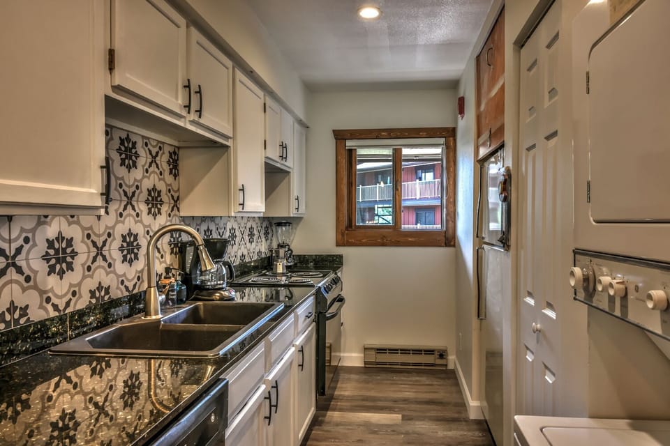 Fully stocked kitchen with washer and dryer in unit