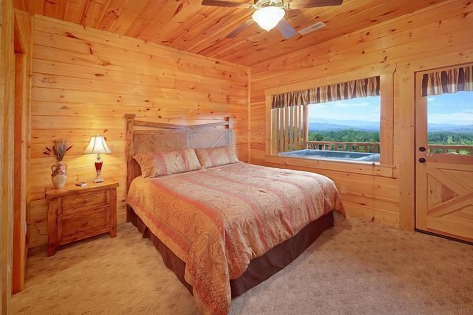 Second bedroom on lower level with door to back deck and hot tub
