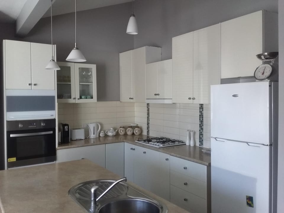 Kitchen with cooking facilities such as oven ,cooktop and refridgerator.