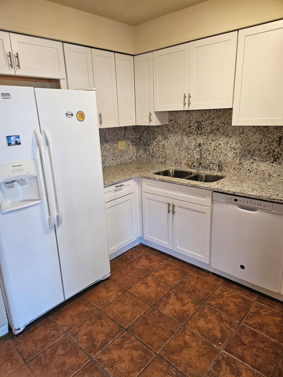 new kitchen with granite countertops and backsplash