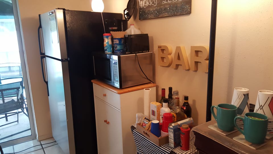 Mini bar with misc libations to enjoy during your stay.  On the go coffee cups. 
