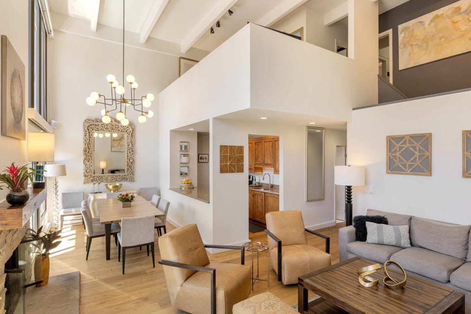 Step into your airy, open-concept living space with soaring ceilings and natural light flooding every corner. Gather around the dining table or sink into the plush seating—your home away from home awaits.