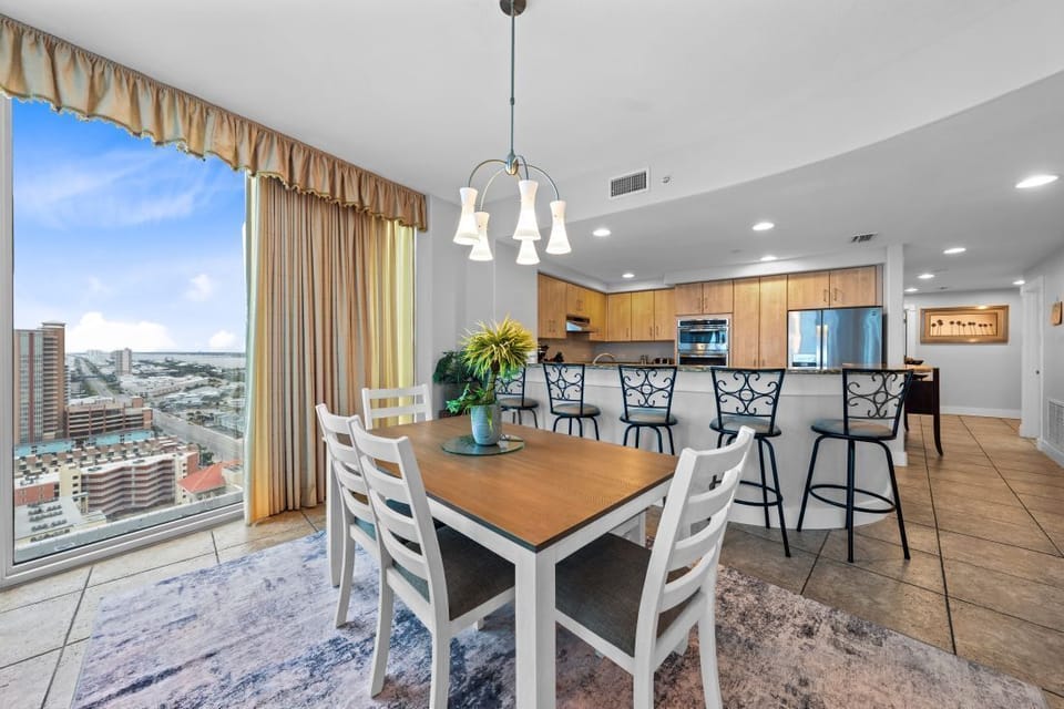 Your open-concept space flows seamlessly from dining to kitchen, with stunning city views creating the perfect backdrop for memorable meals together.