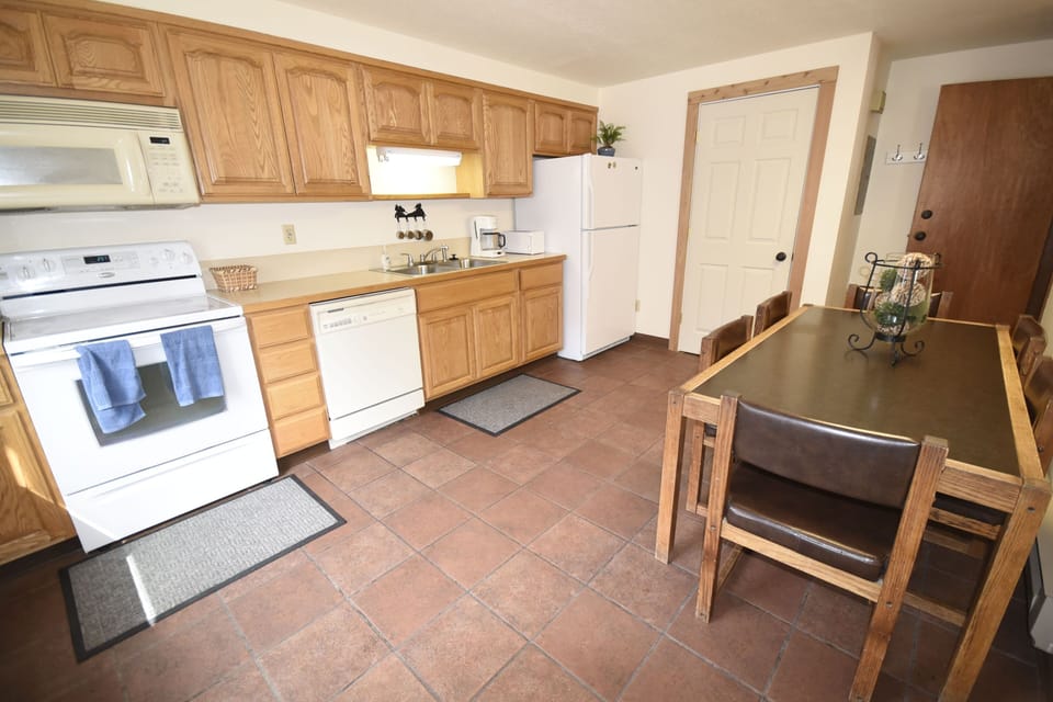 Kitchen with dining table to seat 6, plus two additional chairs in closet