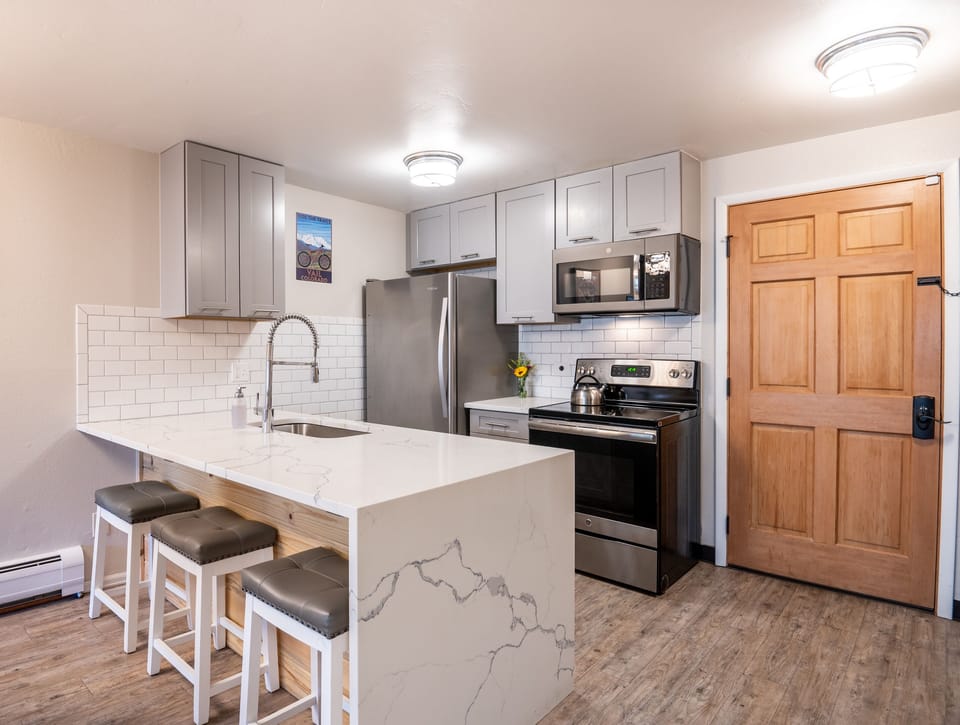 Kitchen and bar area. All stainless steel appliances.