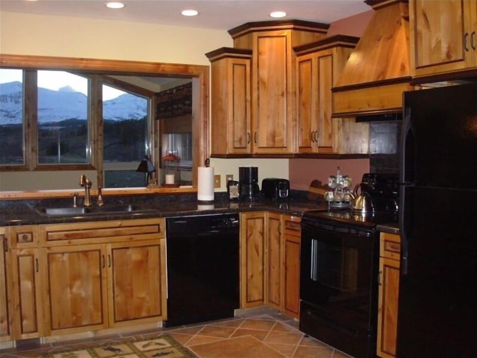 Beautiful kitchen features granite countertops and handcrafted cabinets