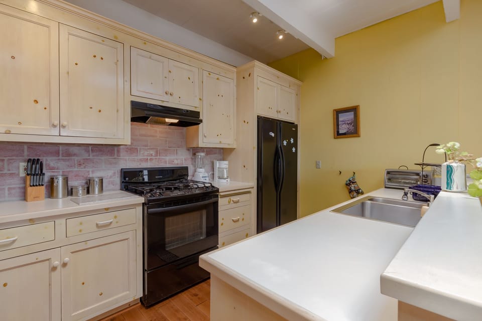equipped kitchen with whitewashed pine cabinetry