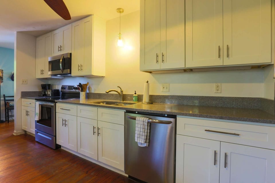 The kitchen also features stainless steel appliances, including a range, microwave, dishwasher and refrigerator.