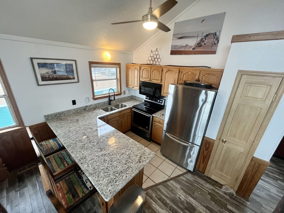 New granite counter top, faucet, dishwasher, fridge, and oven for 2023. 
