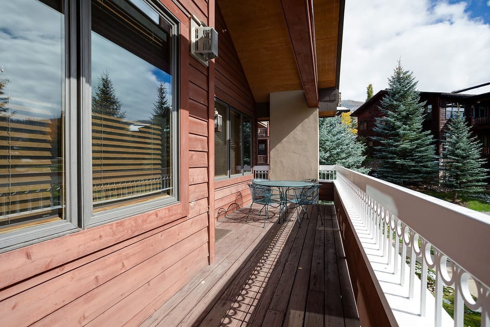 Step onto your private balcony and breathe in the mountain air while enjoying morning coffee at your outdoor dining table.