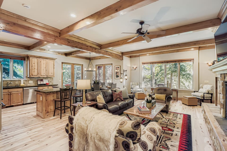 Sink into rich leather seating beneath stunning exposed beams in this warm living space that flows into your fully equipped kitchen.