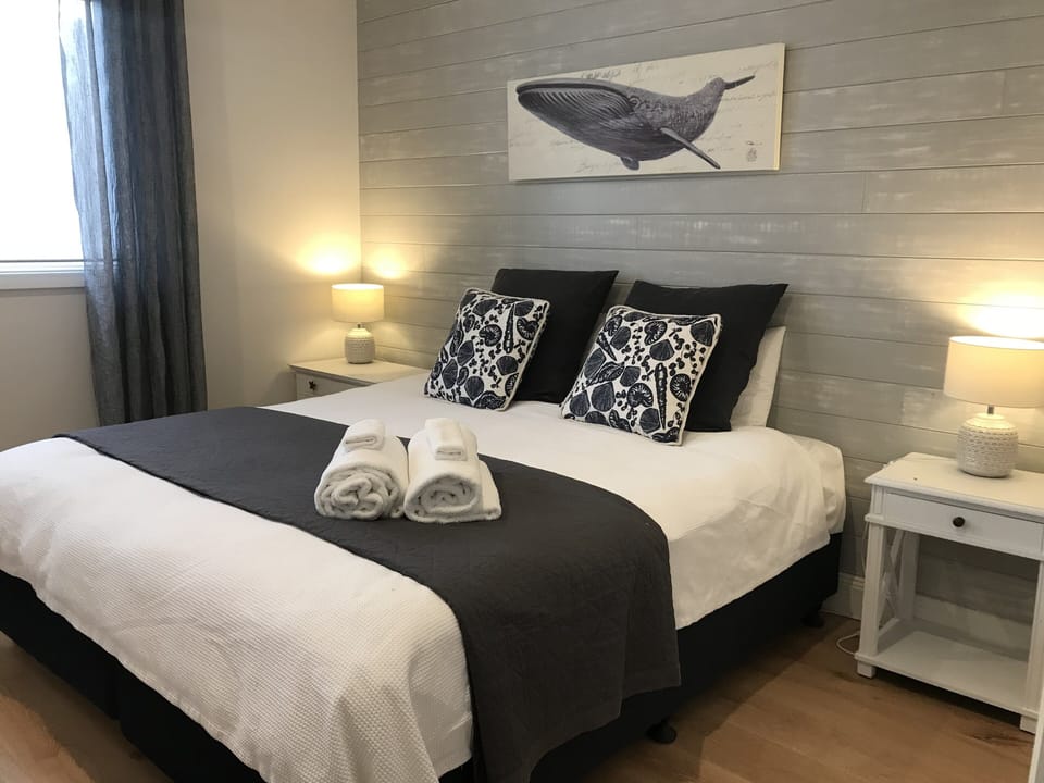 Bedroom 1 with partial views of the ocean (a king bed or 2 large single beds) 