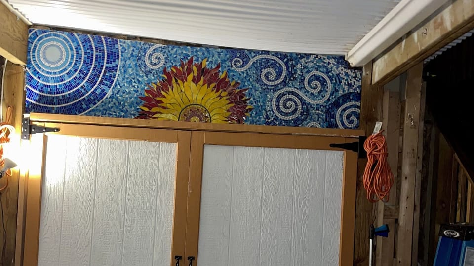 A recent mosaic that John made and is just outside the apartment back door. 