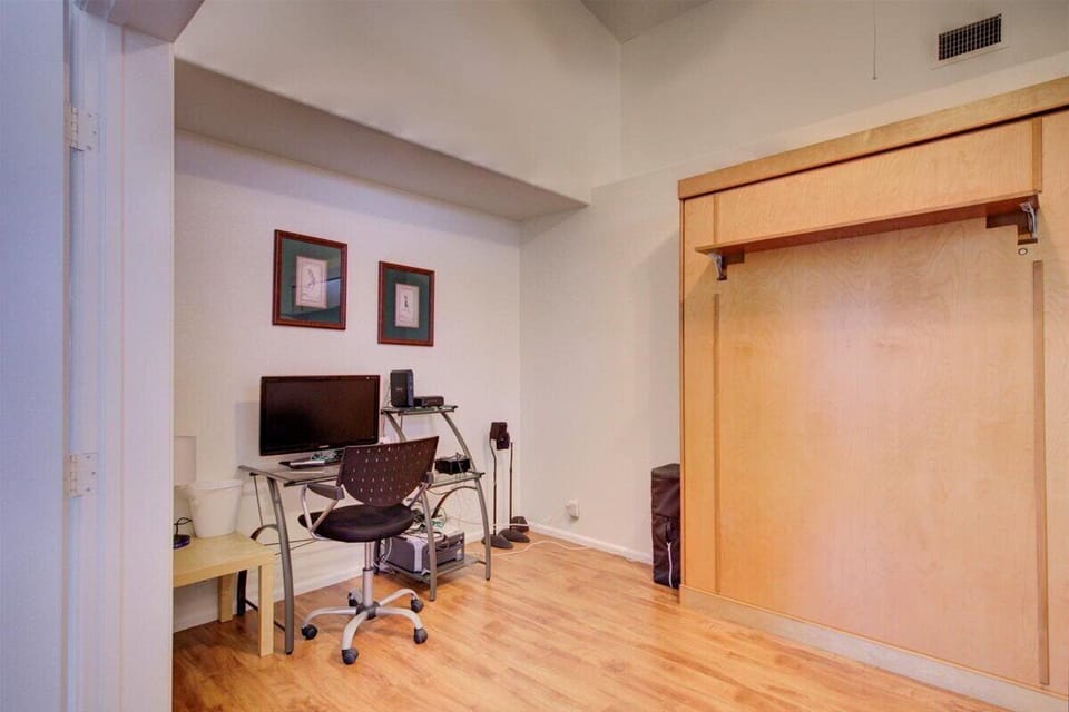 Den off of living room with comfy queen size murphy wall bed