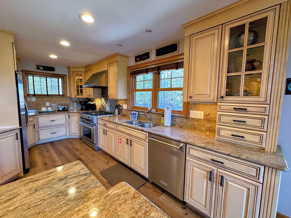 The chef's kitchen, complete with high-end appliances and a separate wine bar, makes entertaining effortless, while the spacious dining area provides the perfect setting for unforgettable gatherings