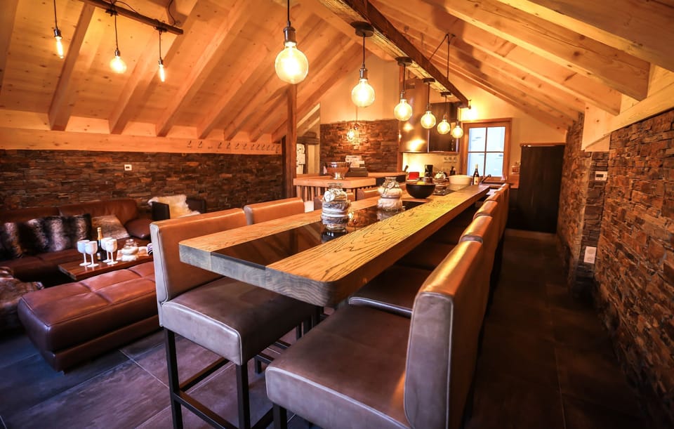 Enjoy meals at the grand dining table with seating.