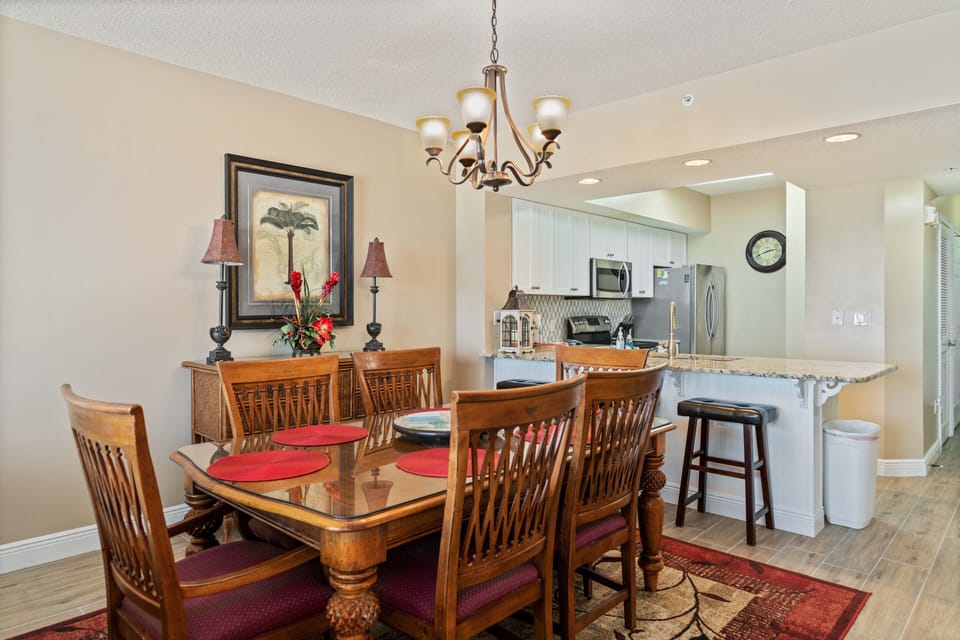 Dining table that seats six with three bar stools.