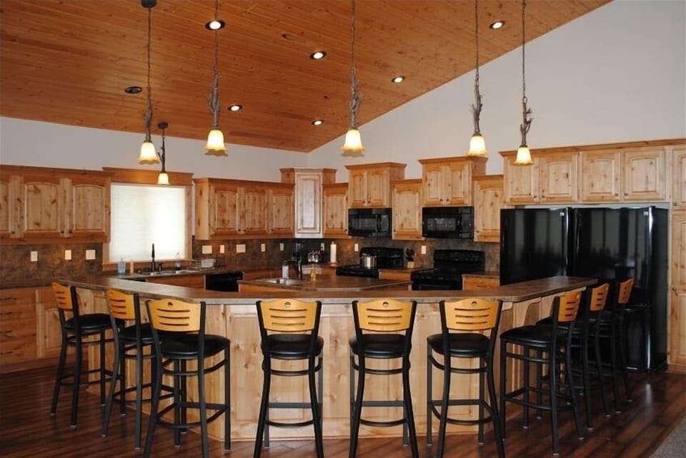 Kitchen with bar; dual appliances and sinks. Seats 9 around bar.