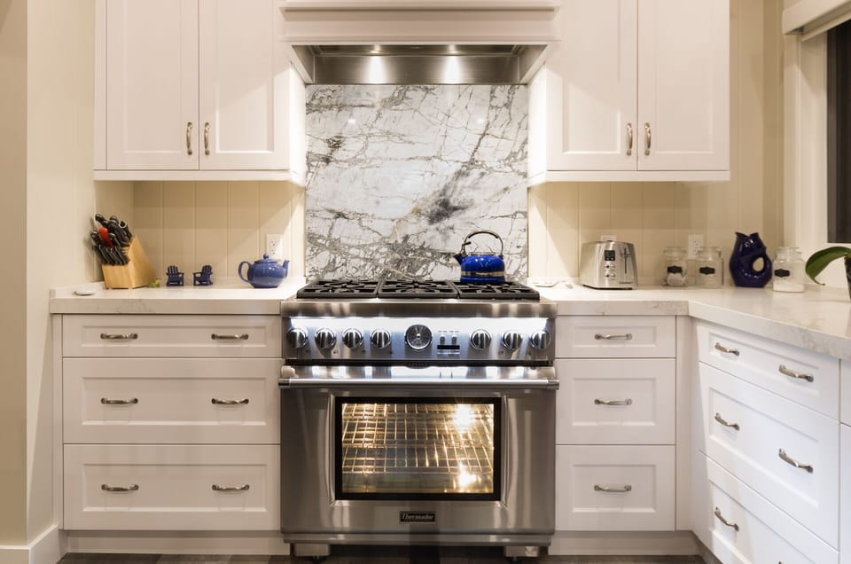 Custom cabinets and finishes. Professional gas & electric stove.