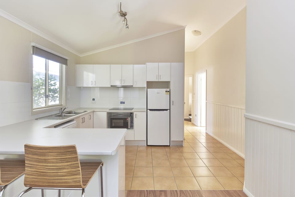 Seabreeze Sands villa | Private kitchen | Full-size fridge, microwave, stovetop, electric kettle