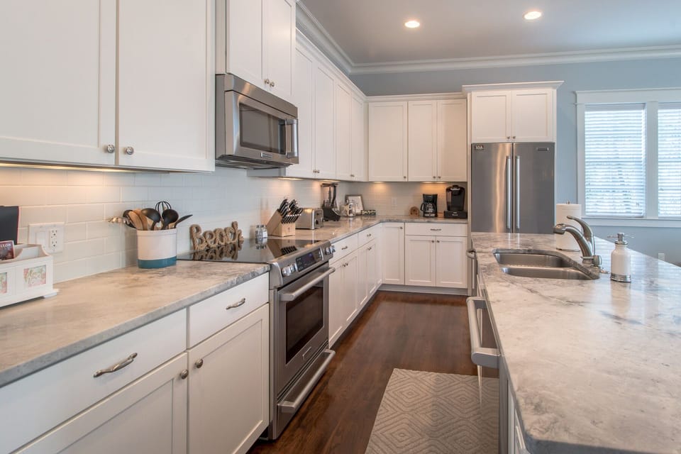 Spacious kitchen with high-end appliances and marble countertop