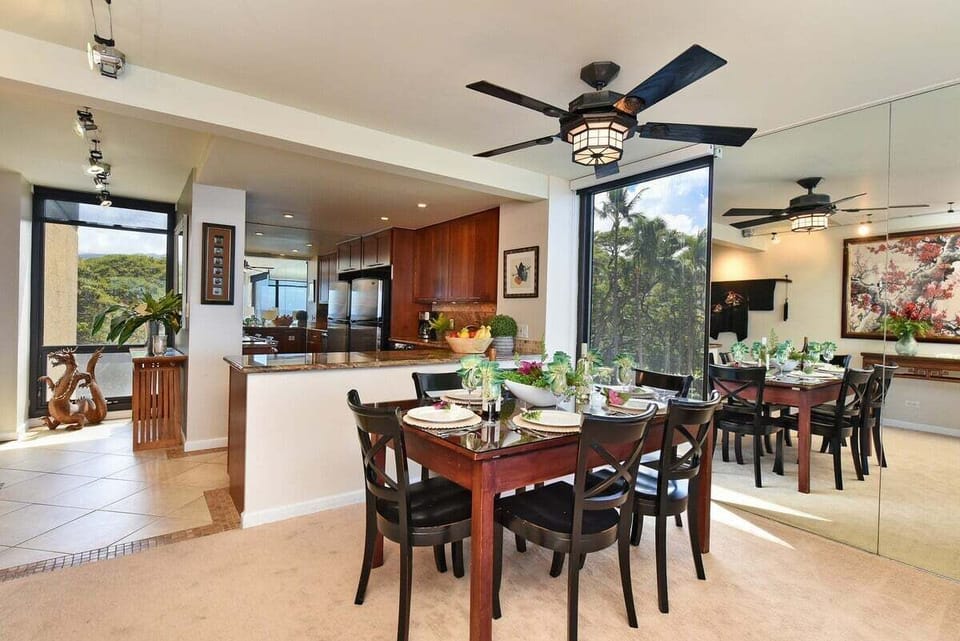 This elegant dining area combines natural light, ocean views, and modern design for a perfect setting
