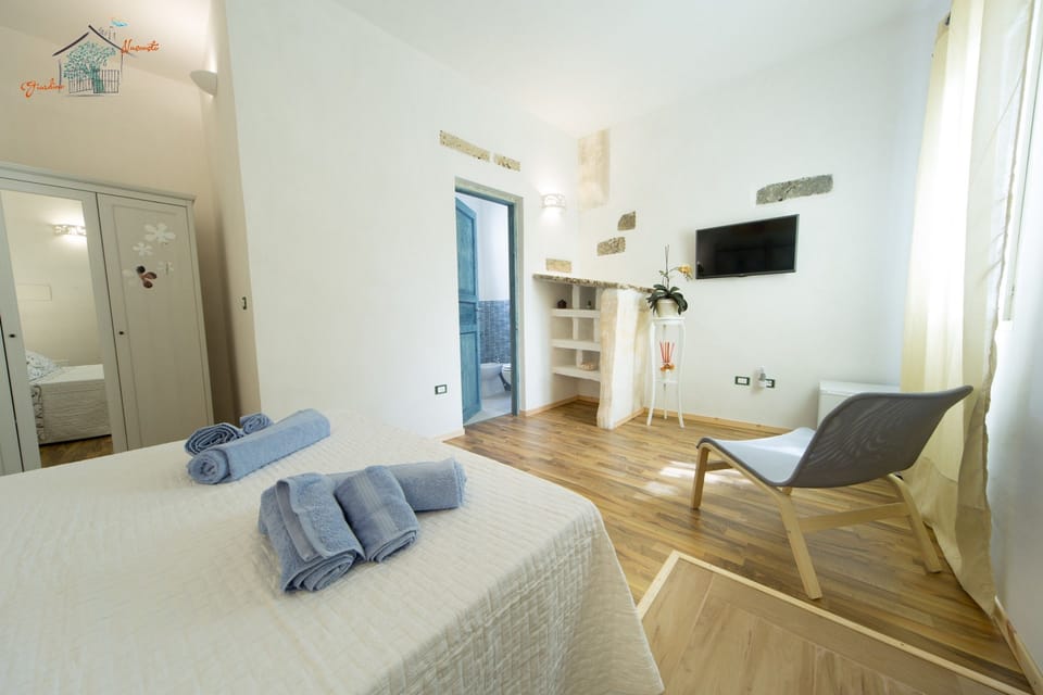 Double Room, Patio, Garden View (Limone) | Minibar, in-room safe, individually decorated, blackout drapes