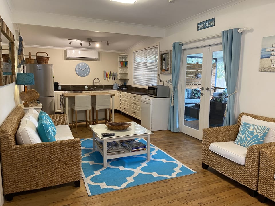 Exit from living area onto the back deck through fold back French doors. 
