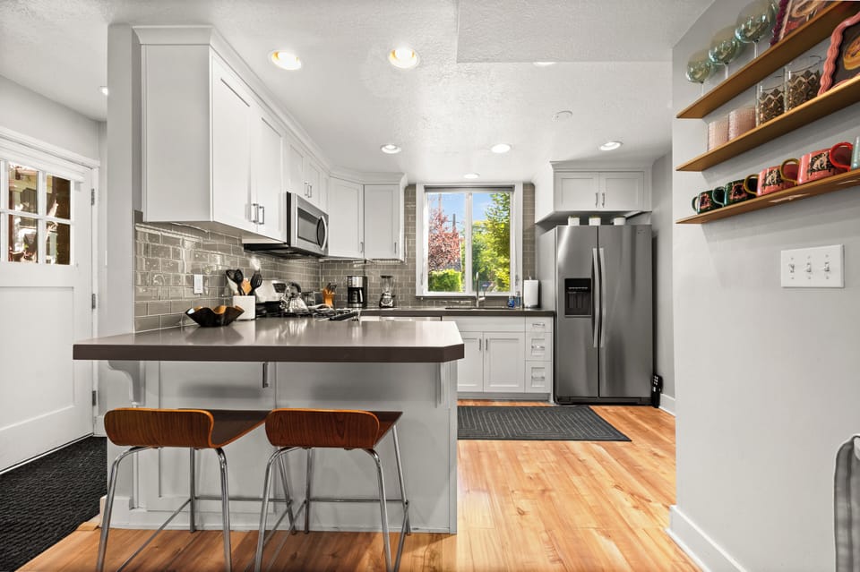 Fully stocked kitchen with utensils, pots/pans, blender, toaster, drip coffee