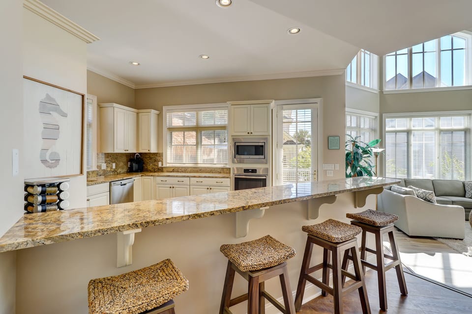 Four counter stools looking in toward the kitchen
