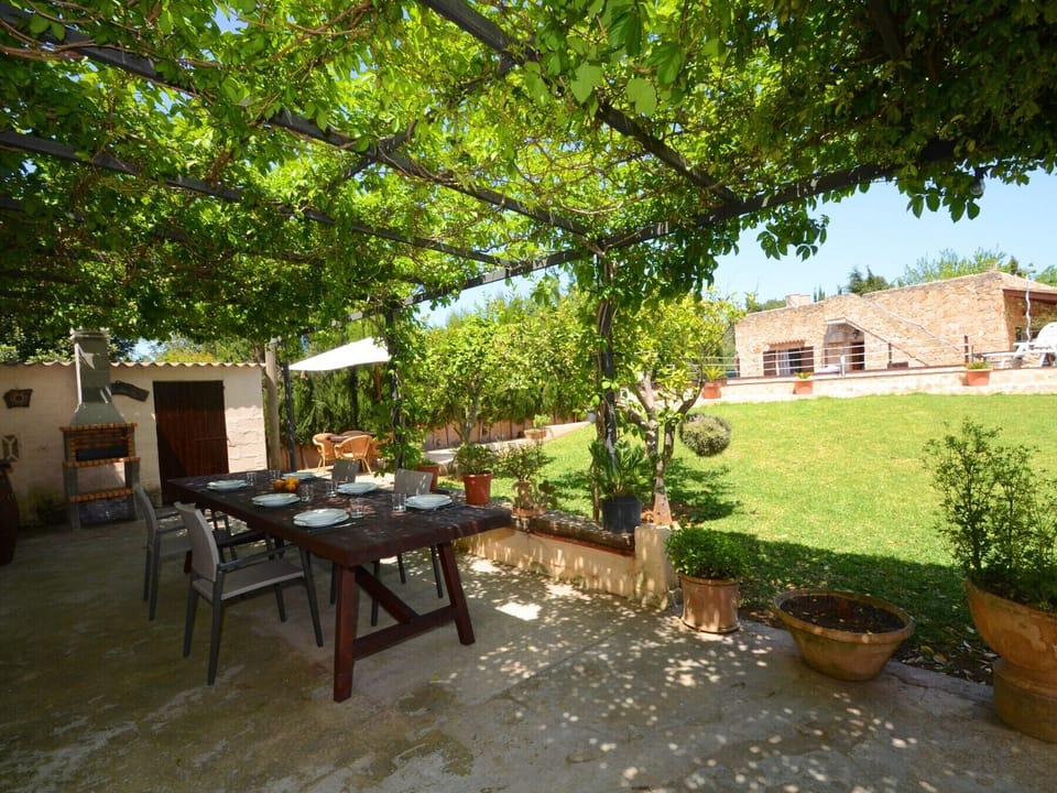 Outside dining room under shade, BBQ, garden and house