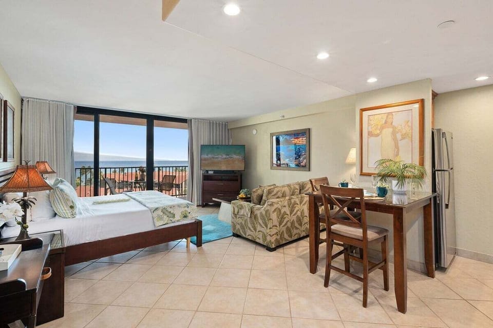Open-concept living and dining area with balcony access